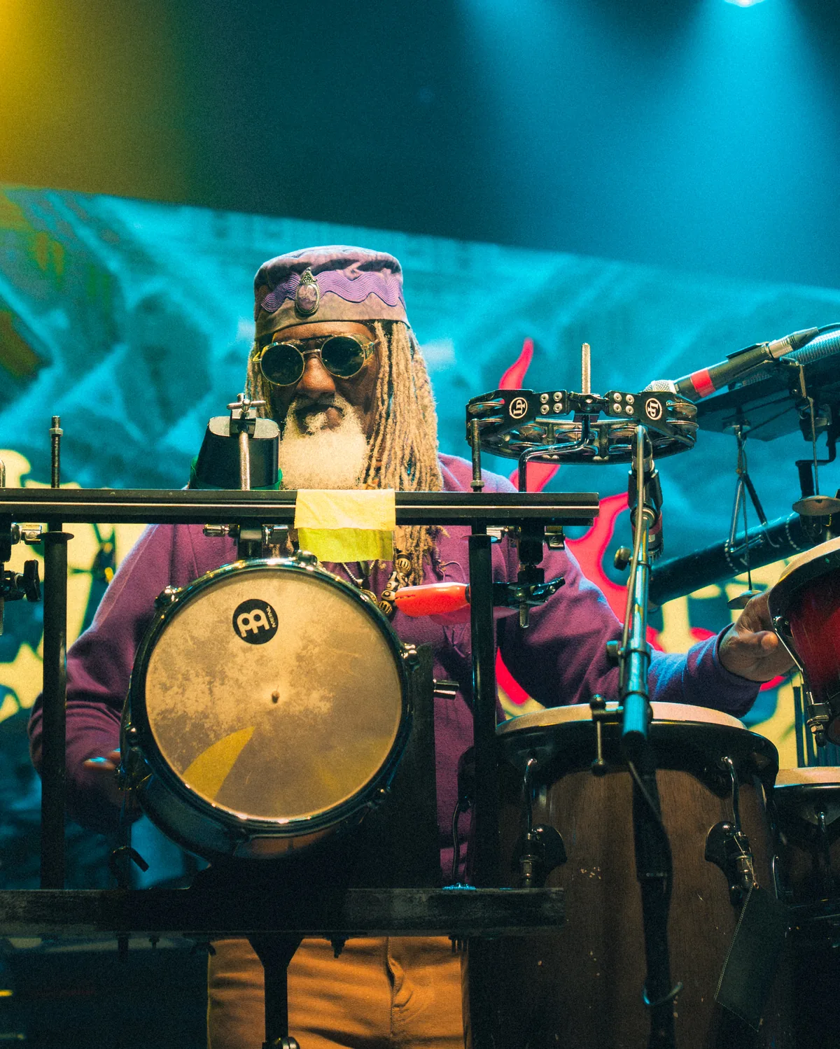 Drummer with long dreadlocks and sunglasses performing behind drum kit in St. Augustine, Florida