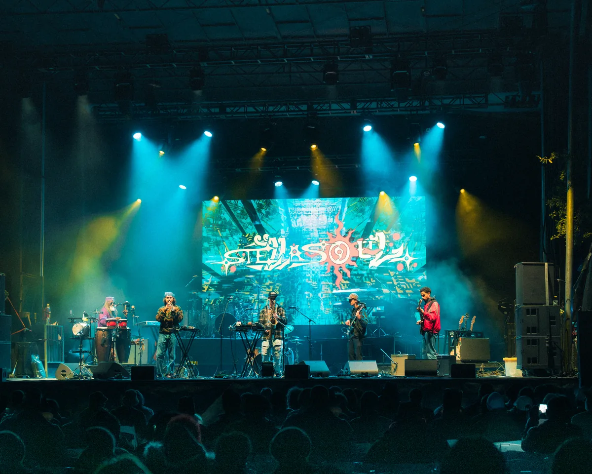 Band performs on stage with colorful lighting at Fort Mose Jazz Festival in St. Augustine, Florida