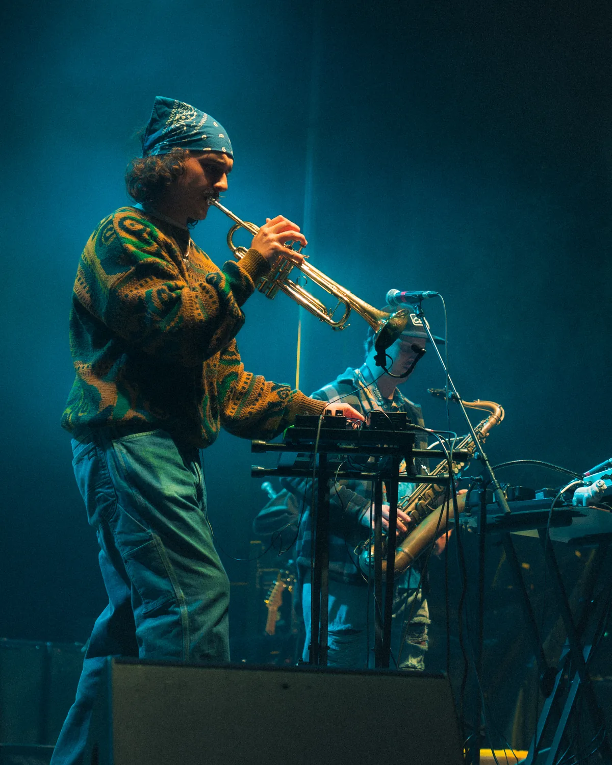 Musician playing trumpet on stage with blue lighting at Fort Mose Jazz Festival in St. Augustine, Florida