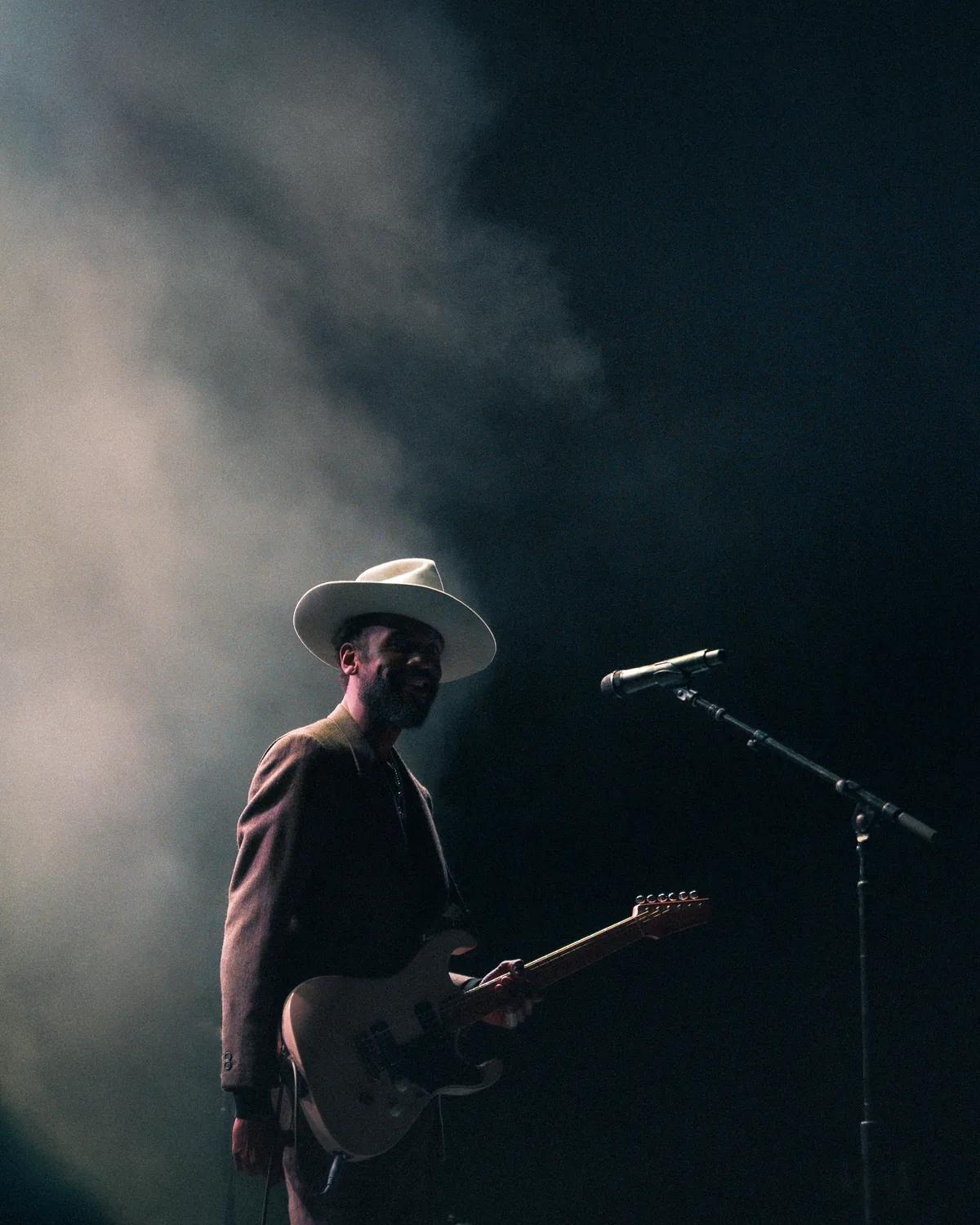 Gary Clark Jr performing with guitar and hat under stage lights in St. Augustine, Florida