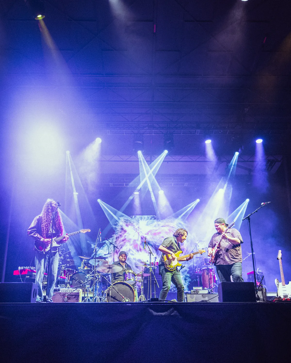 Gilmore Quandry performing live on stage with dramatic blue lighting in St. Augustine, Florida