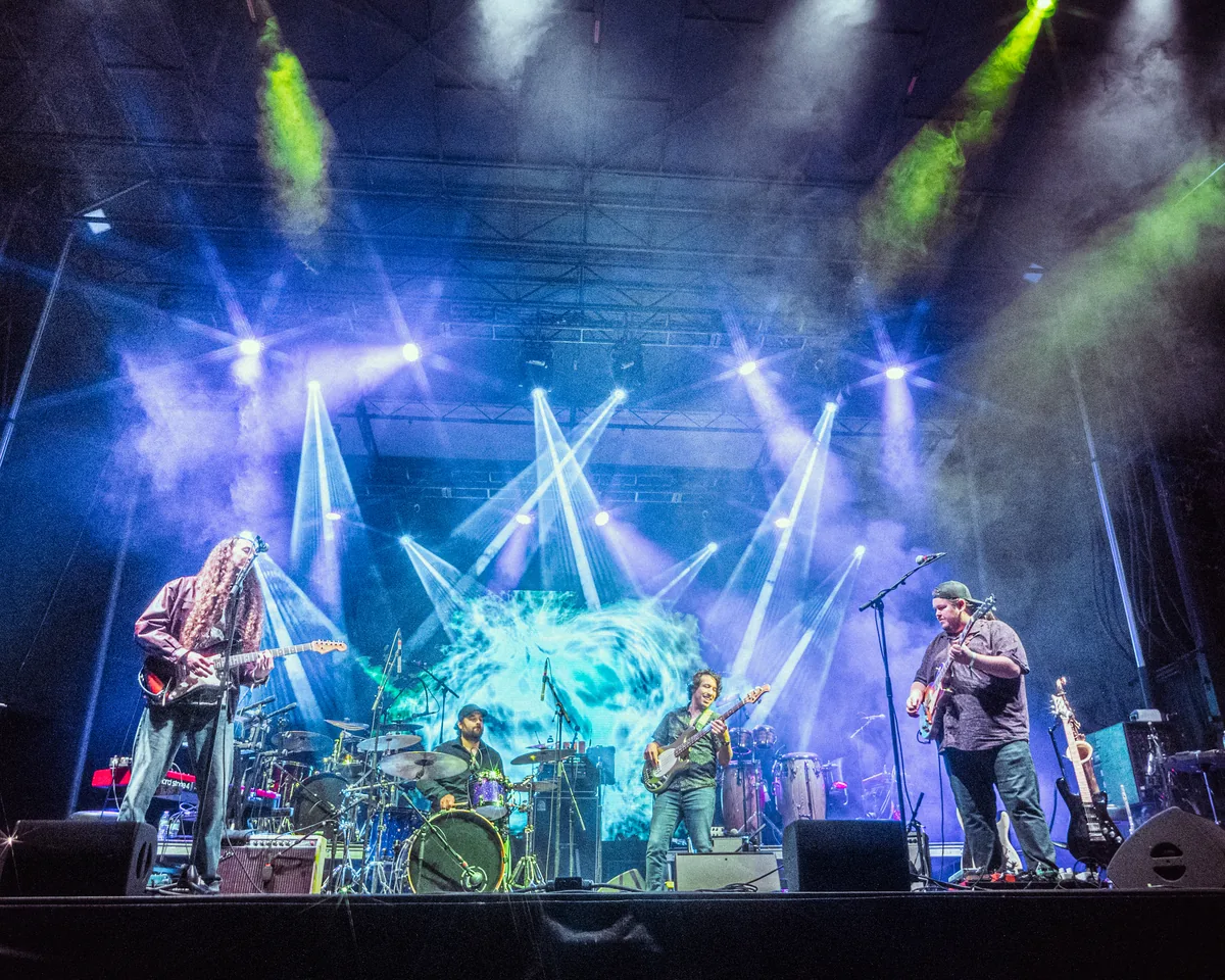 Gilmore Quandry band performing on stage with dramatic blue and green lighting in St. Augustine, Florida